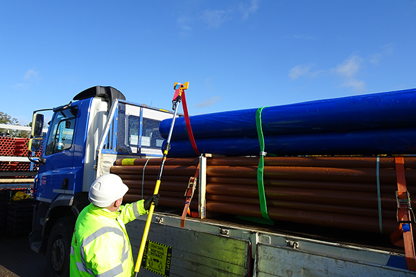 A delegate securing a load on the back of a truck