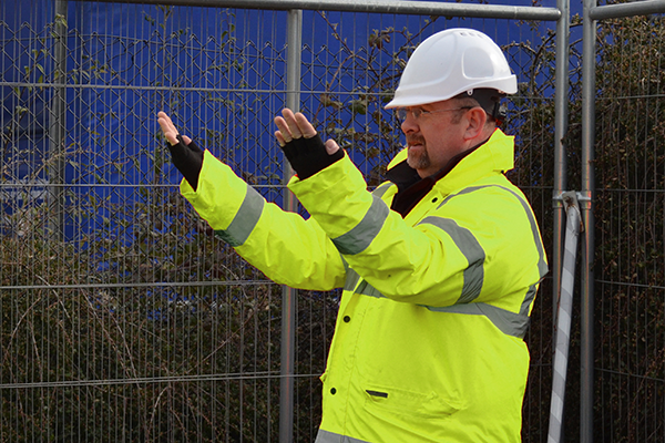An individual carrying out workplace transport marshalling onsite